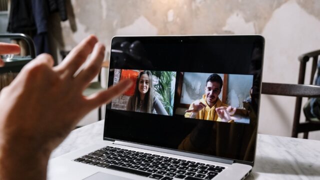 man and woman video call on laptop